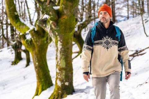 A hiker man on a trekking on the snow, winter adventures, natural activity