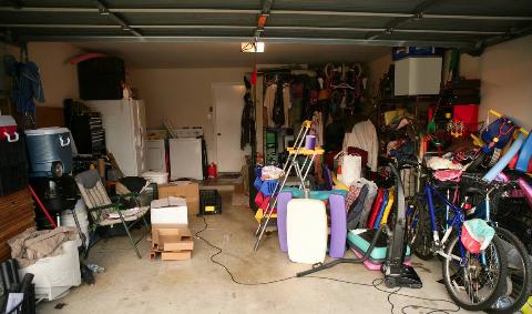 A messy garage full of kid's toys.