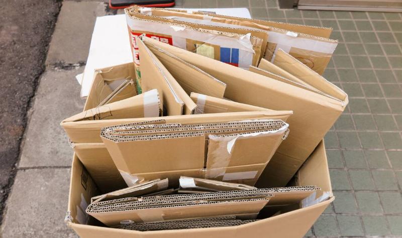 A cardboard box filled with other collapsed and folded cardboard boxes.