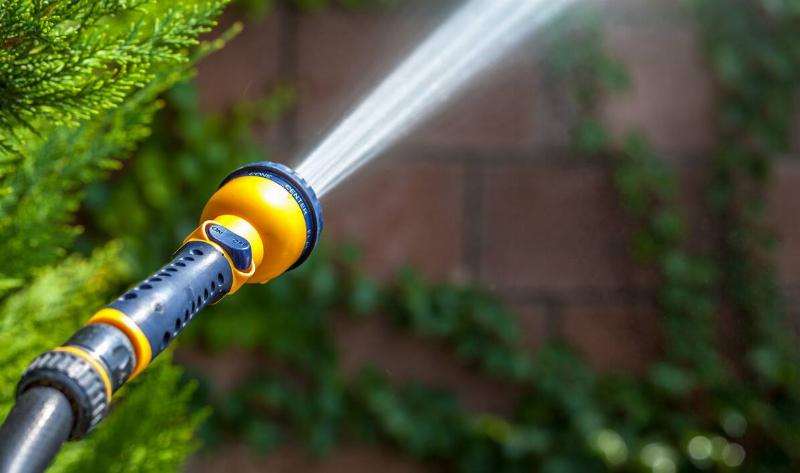 A running hose spraying water forward.