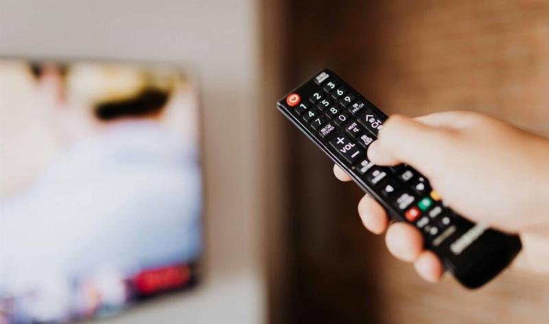 Someone holding a TV remote.