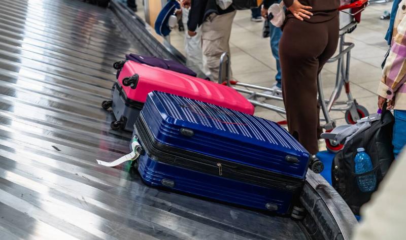 Two suitcases on an airport conveyor.