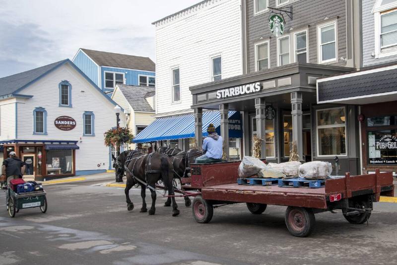 Mackinac Island, Michigan, Only horses and bicycles allowed on the island. Horse and wagon delivering goods to local businesses.