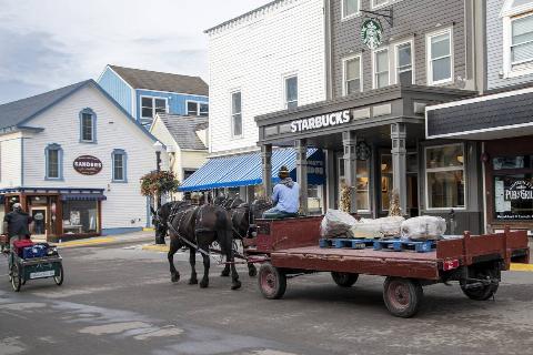 Mackinac Island, Michigan, Only horses and bicycles allowed on the island. Horse and wagon delivering goods to local businesses.