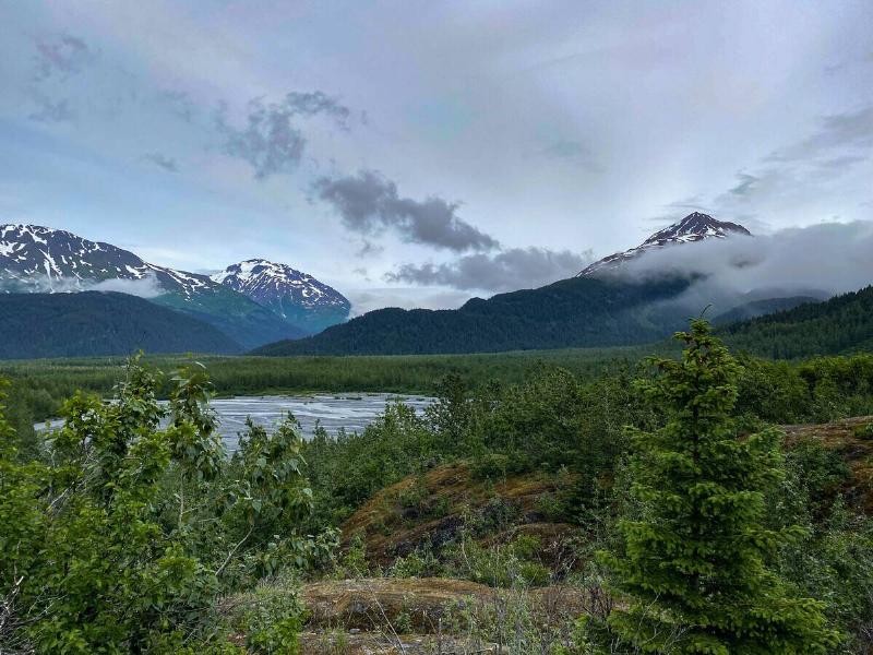 Mountains and small valley area with the drainage of a glacier at Kenai Fjords National Park.