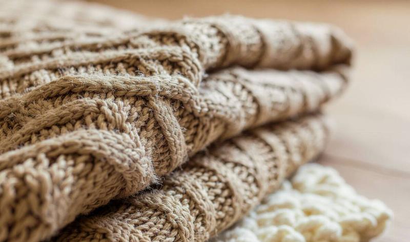 A closeup of some folded wool knit fabric.