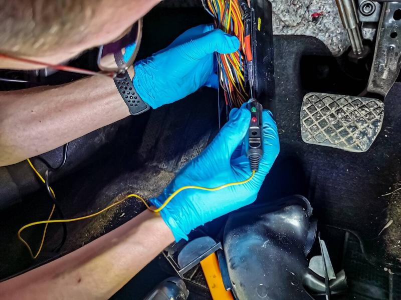 foreman hands check electrical wiring in a modern car close up