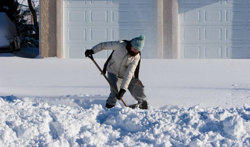 A person shoveling a lot of snow.