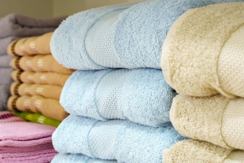 Stacks of neatly folded towels with dobby borders.