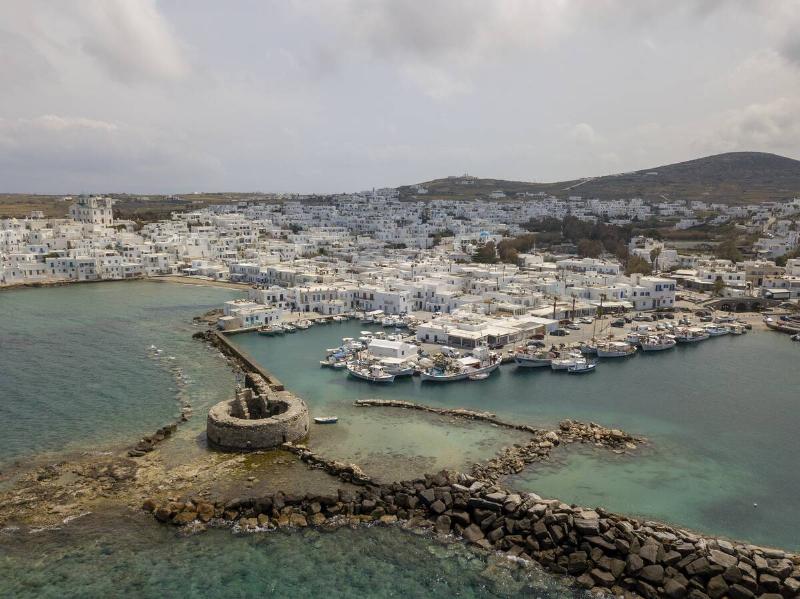 Aerial view of Naoussa picturesque fishing village on April 16, 2021 in Paros, Greece.
