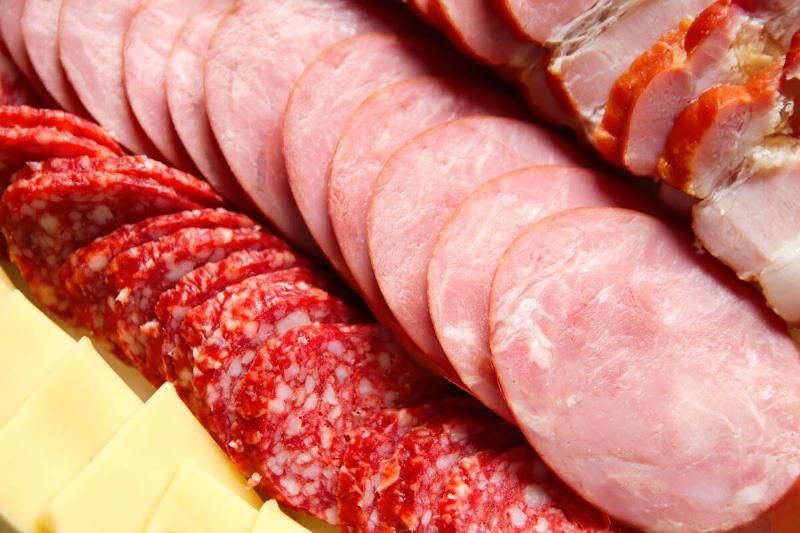 Cheese and various processed meats on a platter