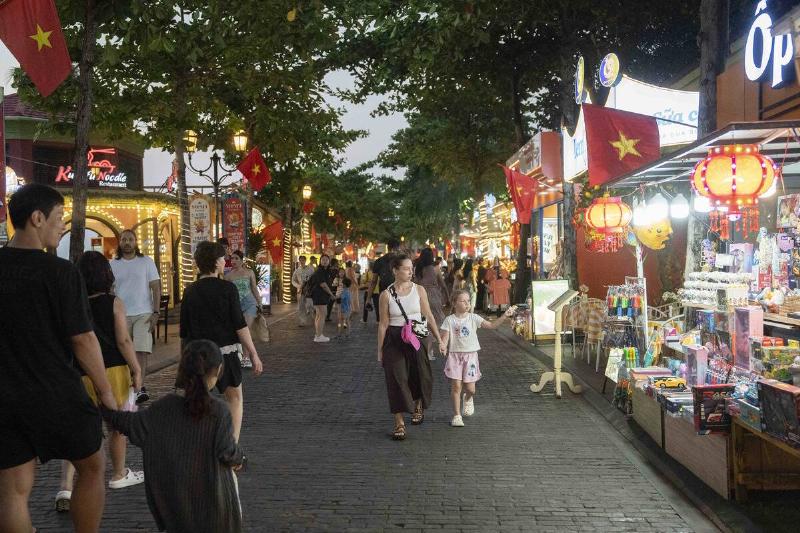 Tourists walk along Sunset Town night market on March 19, 2026 in Phu Quoc Vietnam.