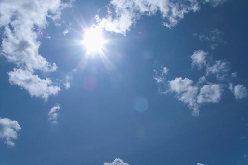 The sun is shining bright in the sky. 