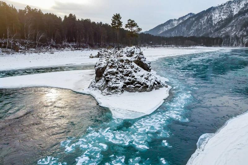 A cold river in a snowy landscape. 