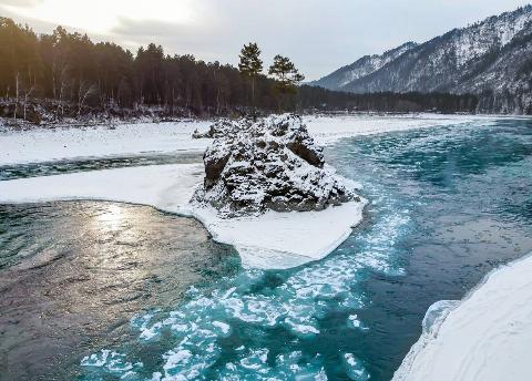 A cold river in a snowy landscape. 