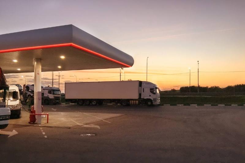 A truck at a gas station. 