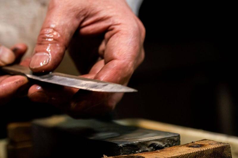 Hands making a knife. 