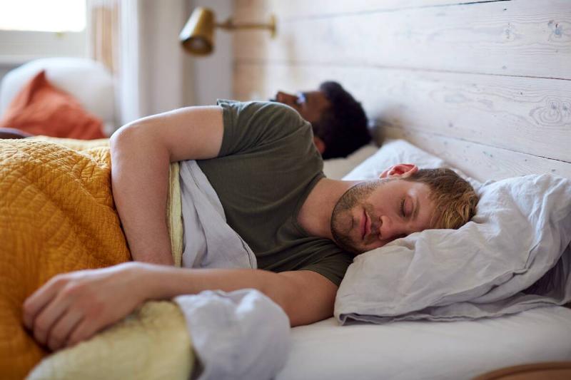A man sleeping in a bed. 