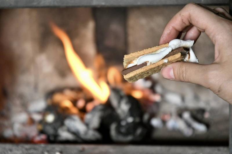 S'mores being held in front of a fire. 