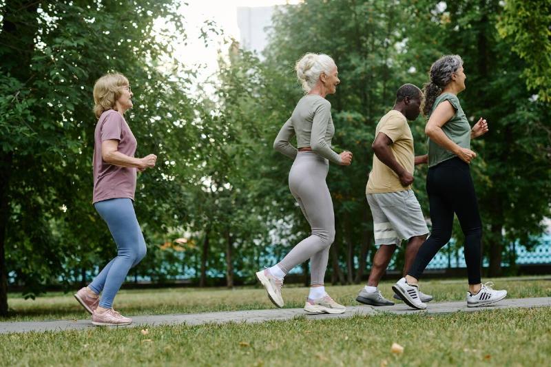 Four seniors running on a path together. 