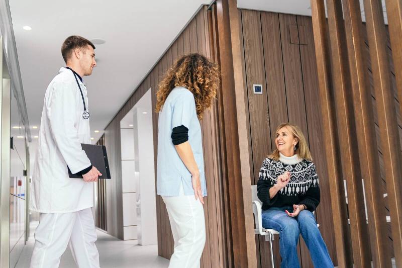 A woman talking to a doctor at a hospital. 