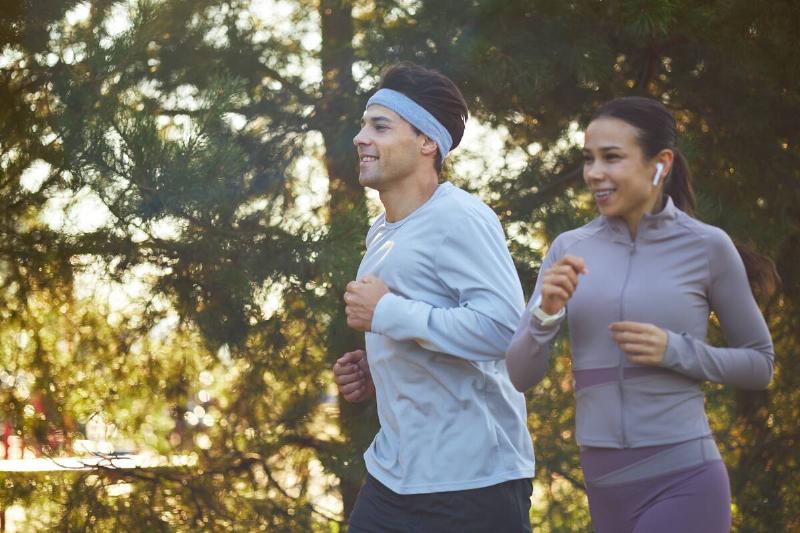 Man and woman running outside together. 