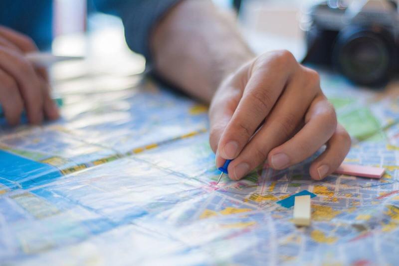 A person's arm on a map. 