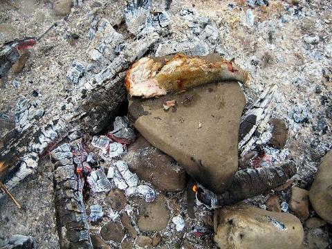 Fish cooking on a rock. 