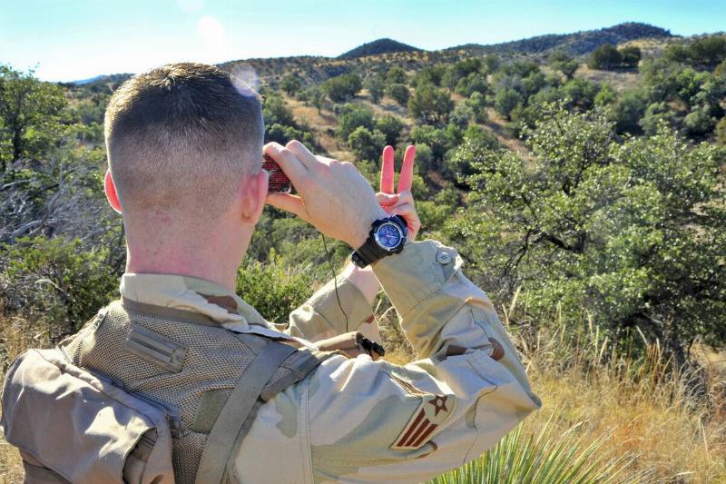 U.S. Air Force Airman 1st Class Andrew Stranger, 355th Operations Support Squadron intelligence analyst, uses a mirror to signal his location.