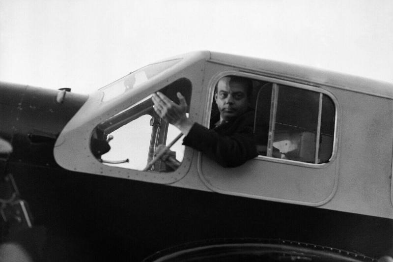 Portrait of Antoine de Saint-Exupery, aviator and writer, in the cockpit of his airplane.