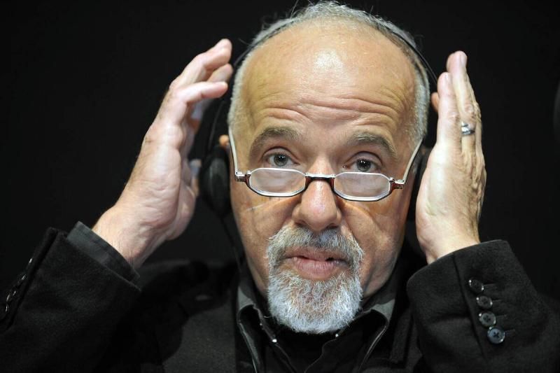 Author Paulo Coelho adjusts his headset.