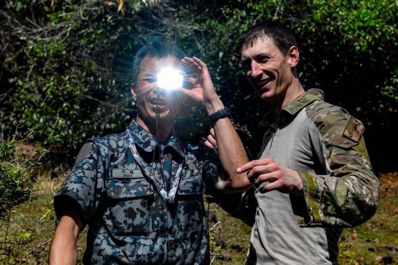 Master Sgt. Kurt Douge, the superintendent of the personnel recovery division at the 353rd Combat Training Squadron, demonstrates how to use a signal mirror