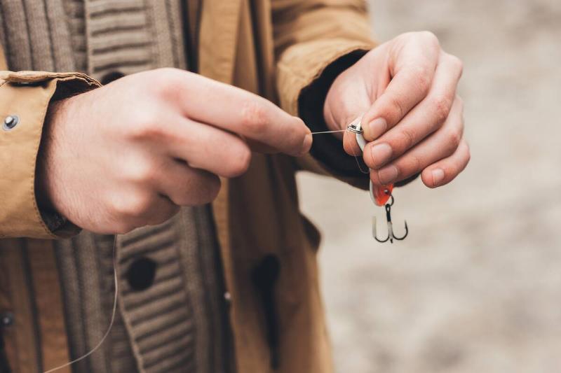 Cropped shot of man holding fishing tackle.