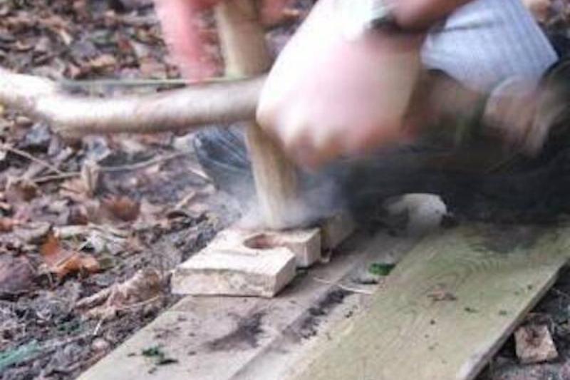 A person using a bowdrill. 
