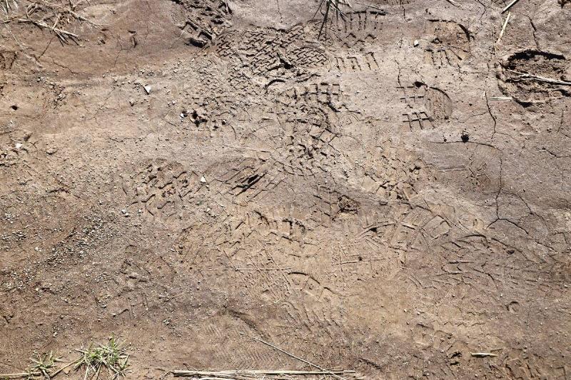 Old boot tracks in dirt.