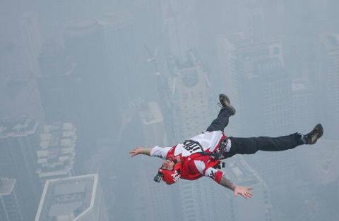 A BASE jumper soars through the air after diving from Malaysia's Kuala Lumpur Tower.