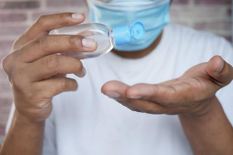 Person putting hand sanitizer on their hands.