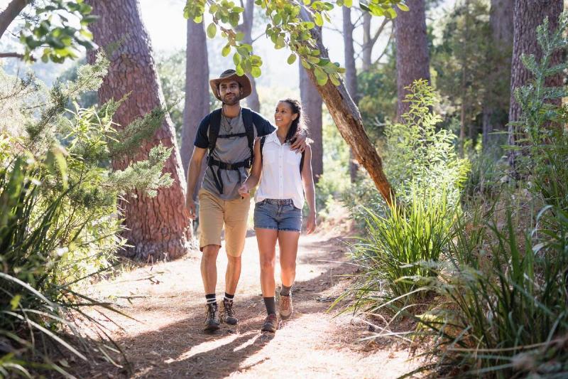 A couple walking together on a trail. 