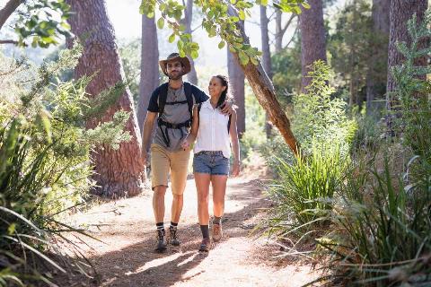A couple walking together on a trail. 