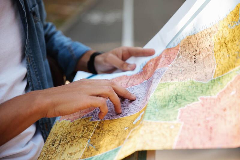 Man looking at colorful map. 