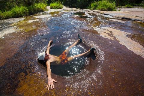 Man relaxing in natural hot springs. 