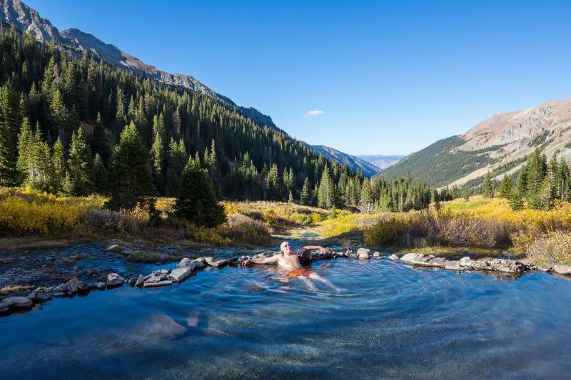 A man relaxing in a natural hot springs.