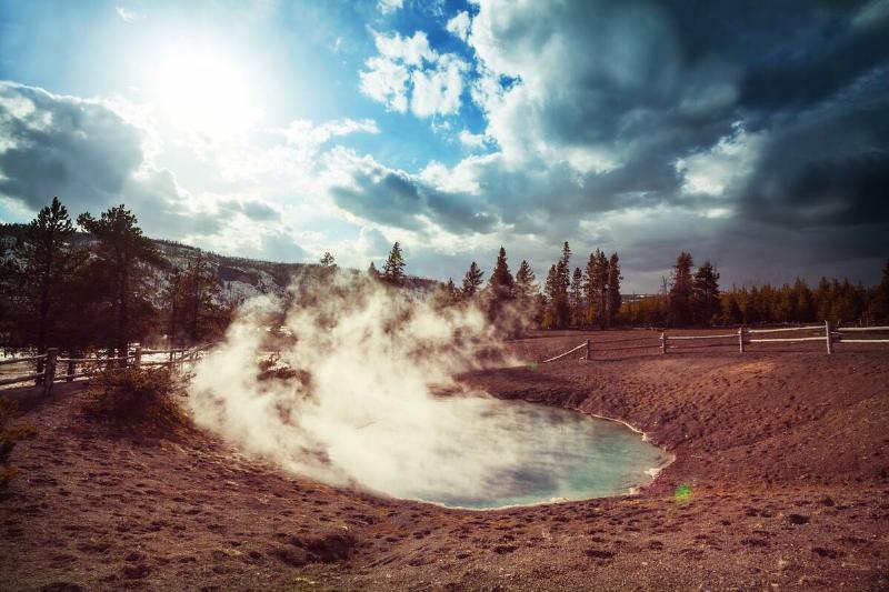 Steam coming off of a hot springs pond. 