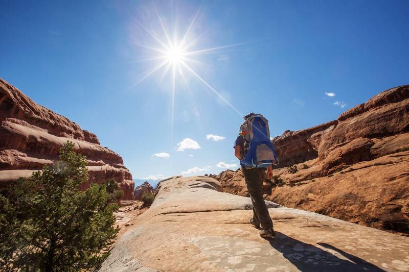 hiker under high sun in arches national park utah usa