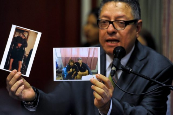 Carlos Guzman, representative of the Masonek Law Offices, attorney of Salvadorean castaway Jose Salvador Alvarenga, shows pictures of his client in the Marshalls islands, during a press conference in San Salvador. AFP PHOTO/ Jose CABEZAS. Photo by JOSE CABEZAS/AFP/Getty Images