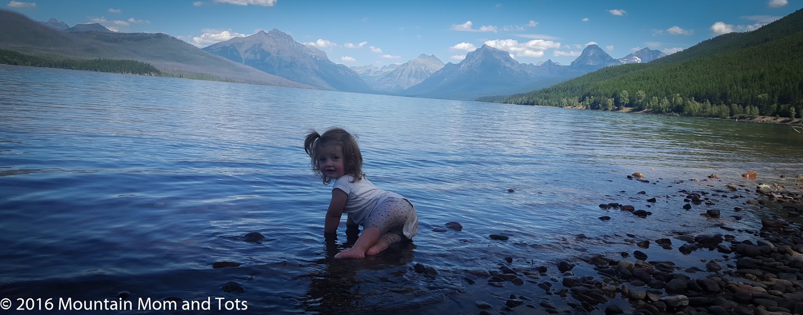 Baby L in Lake McDonald. Glacier-less mountains in the distance.