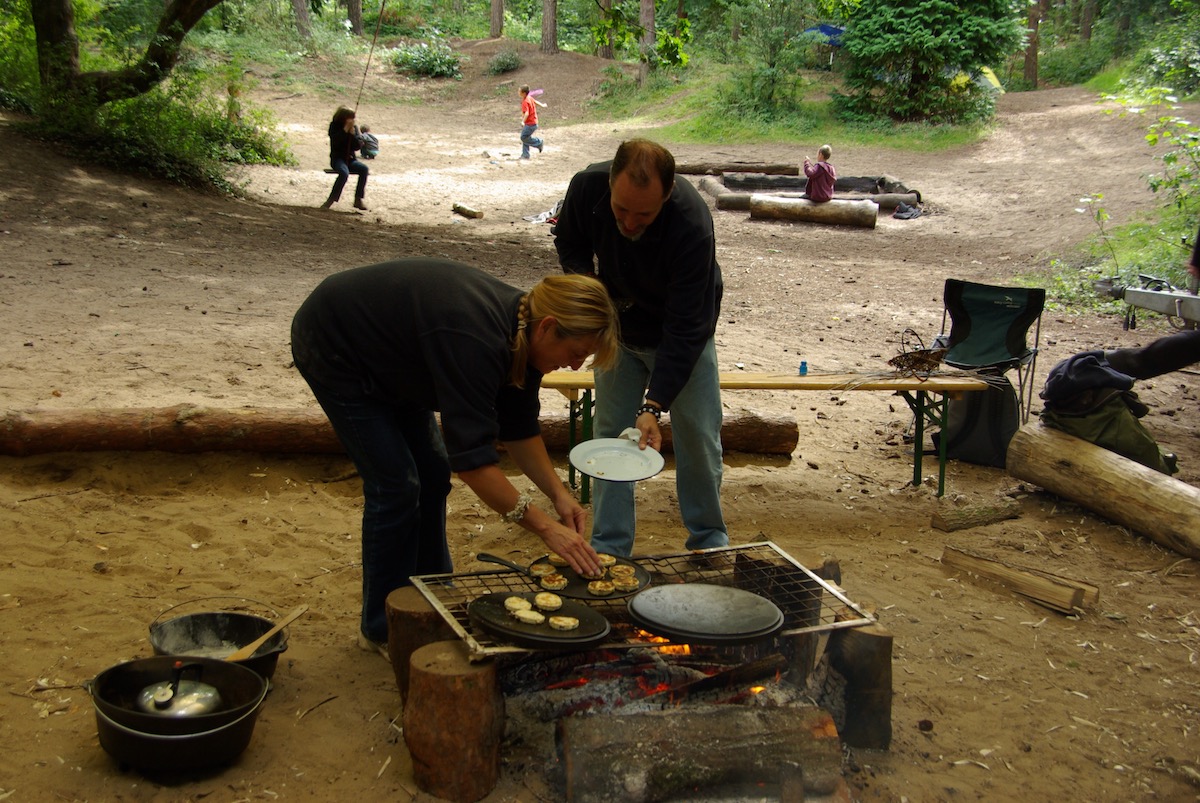 Dutch oven lids being used to cook drop scones