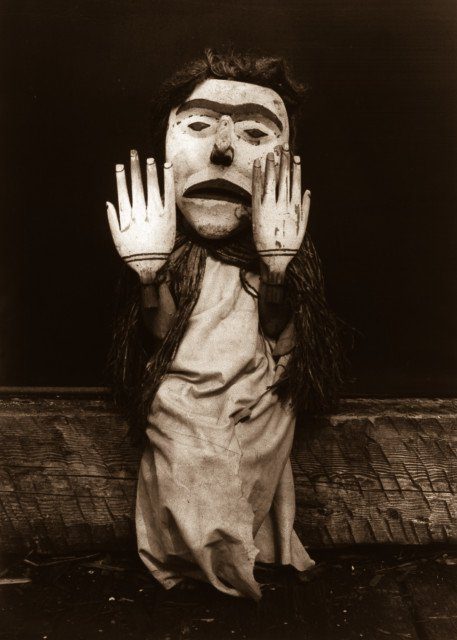A Kwakiutl person dressed as a forest spirit, Nuhlimkilaka, (‘bringer of confusion’).1914