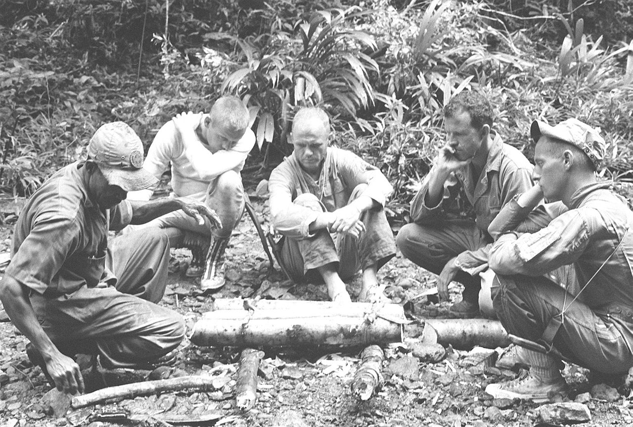 Astronauts participating in tropical survival training at an Air Force Base near the Panama Canal, 1963. From left to right are an unidentified trainer, Neil Armstrong, John H. Glenn, Jr., L. Gordon Cooper, and Pete Conrad.