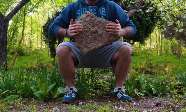 For more effective squats, hold a rock in your hands